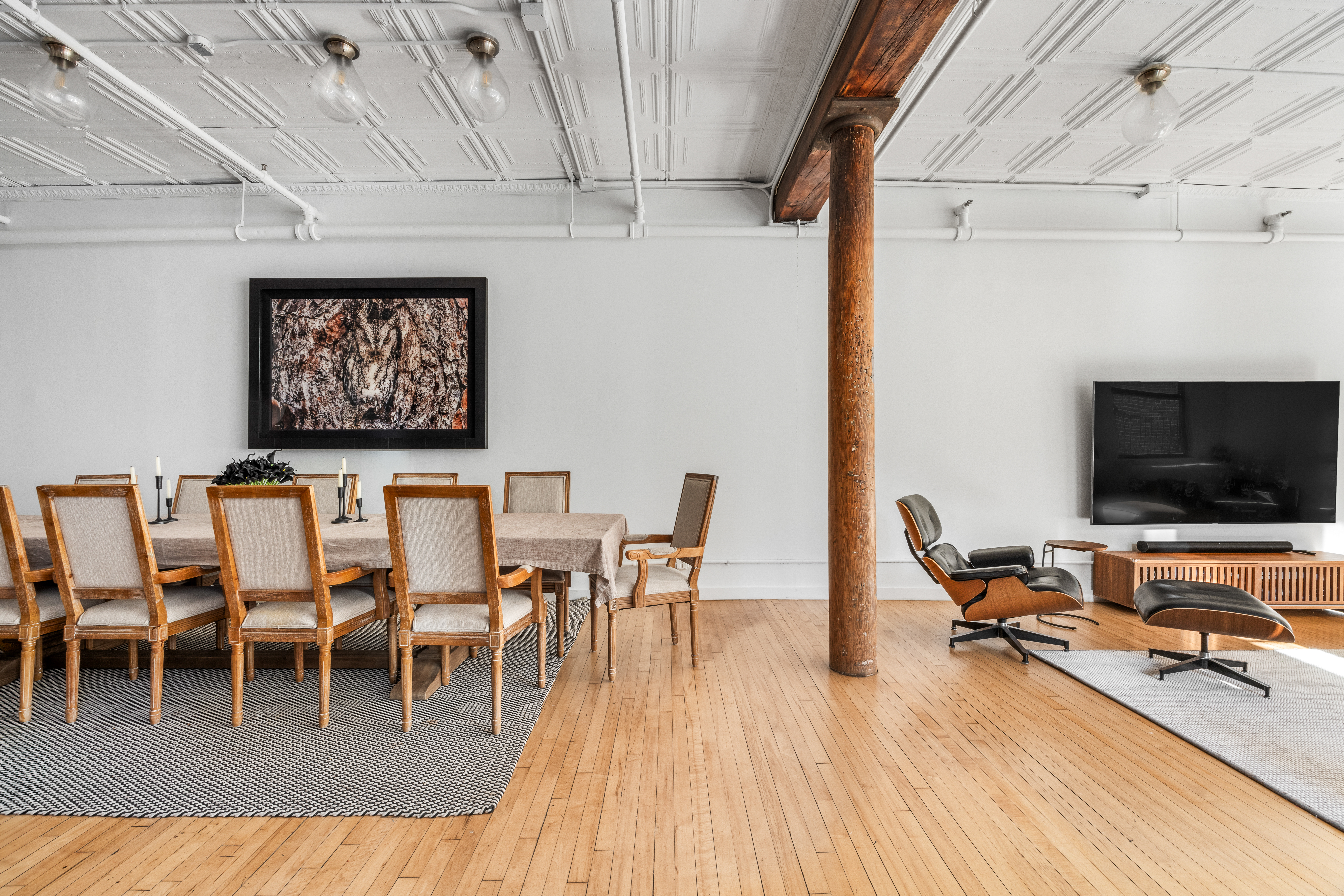5 White Street, Unit 5B Manhattan, NY 10013 - Photo 7 of 21 a dining room with furniture wooden floor a rug and a chandelier