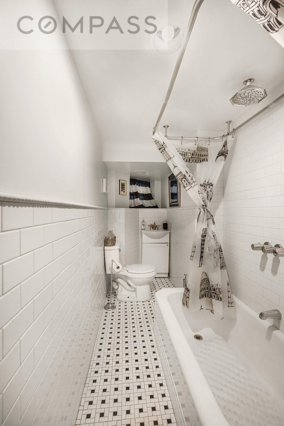 69 Sterling Street Brooklyn, NY 11225 - Photo 12 of 14 a bathroom with a sink a toilet and a mirror