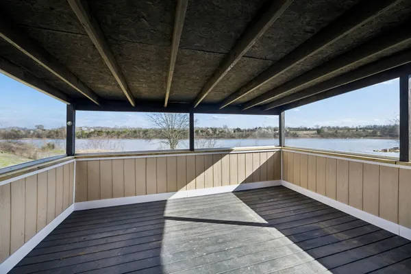 a view of balcony with wooden floor