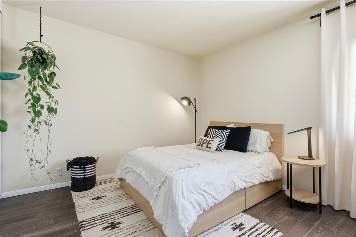 6373 Rancho Mission Road, Unit 5 San Diego, CA 92108 - Photo 18 of 30 a bedroom with a bed and a potted plant