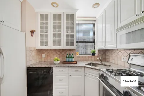 a kitchen with stainless steel appliances granite countertop a stove and a sink