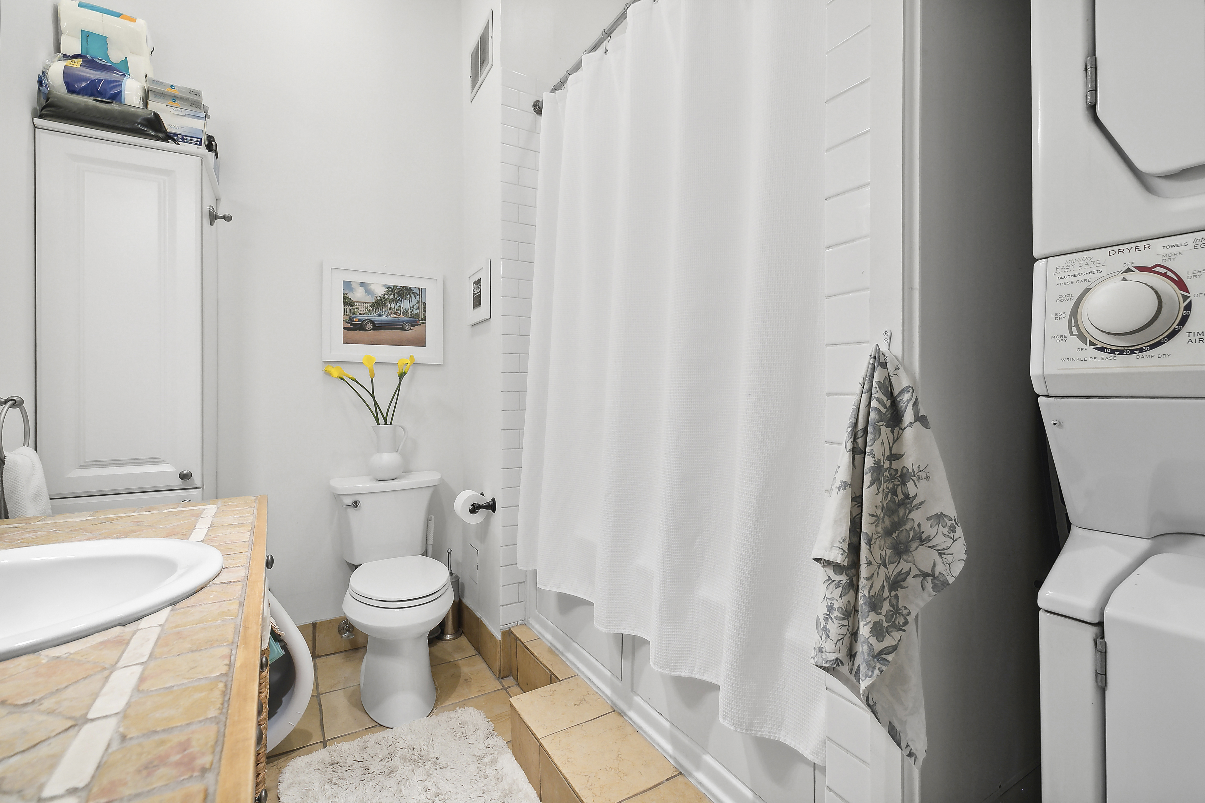 116 Franklin Street, Unit 3 Manhattan, NY 10013 - Photo 4 of 9 a bathroom with a toilet sink and shower curtain