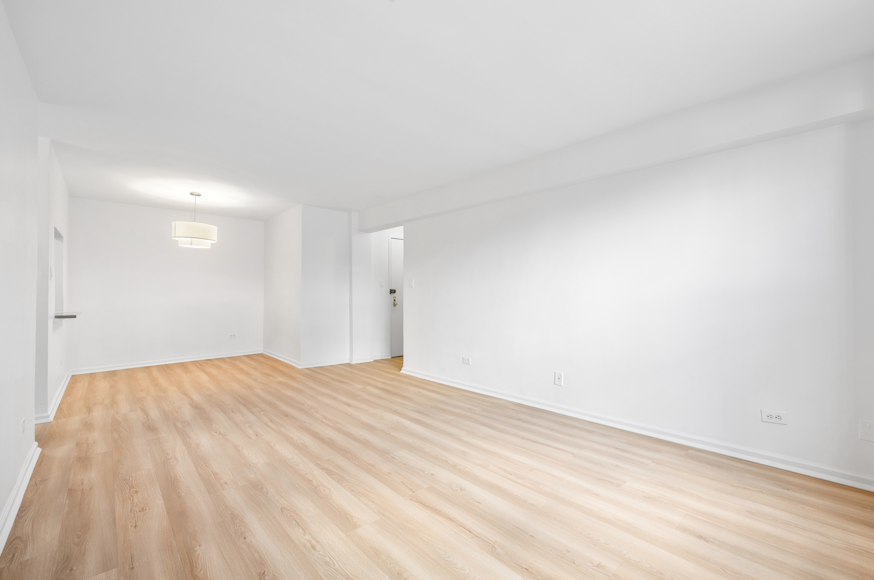 35-20 Leverich Street, Unit B226 Queens, NY 11372 - Photo 4 of 15 a view of empty room with wooden floor