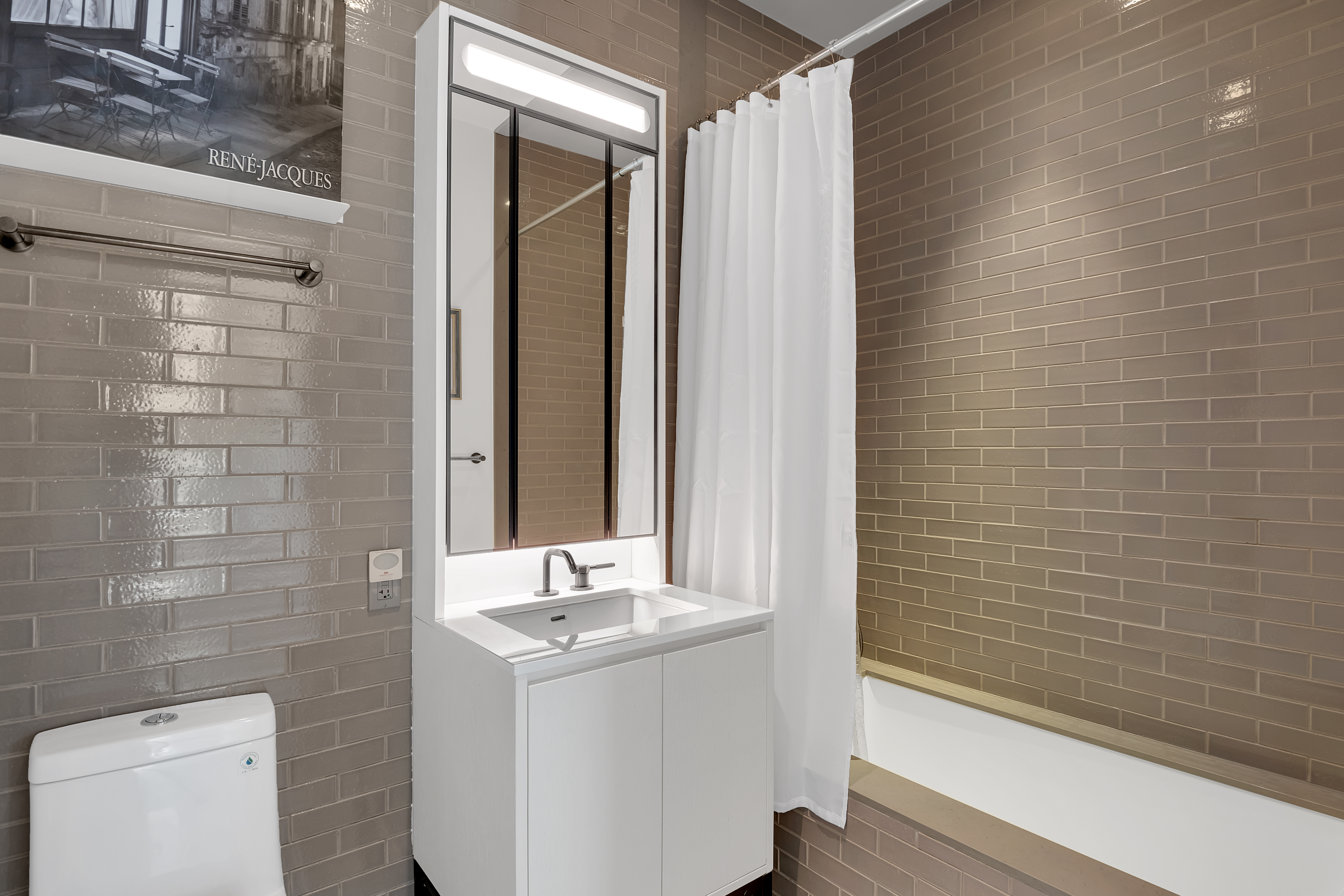 959 1st Avenue, Unit 25H Manhattan, NY 10022 - Photo 11 of 18 a bathroom with a sink a toilet and shower