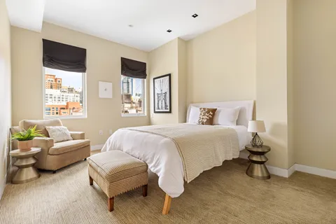 a bedroom with a bed and a couch