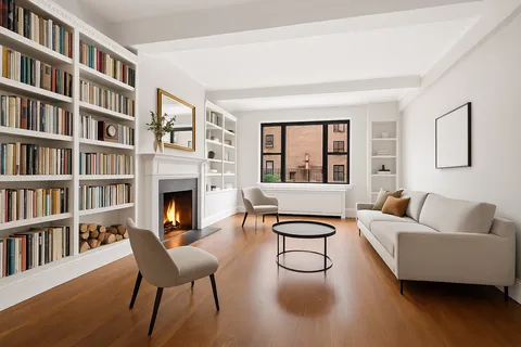 a living room with furniture and a book shelf