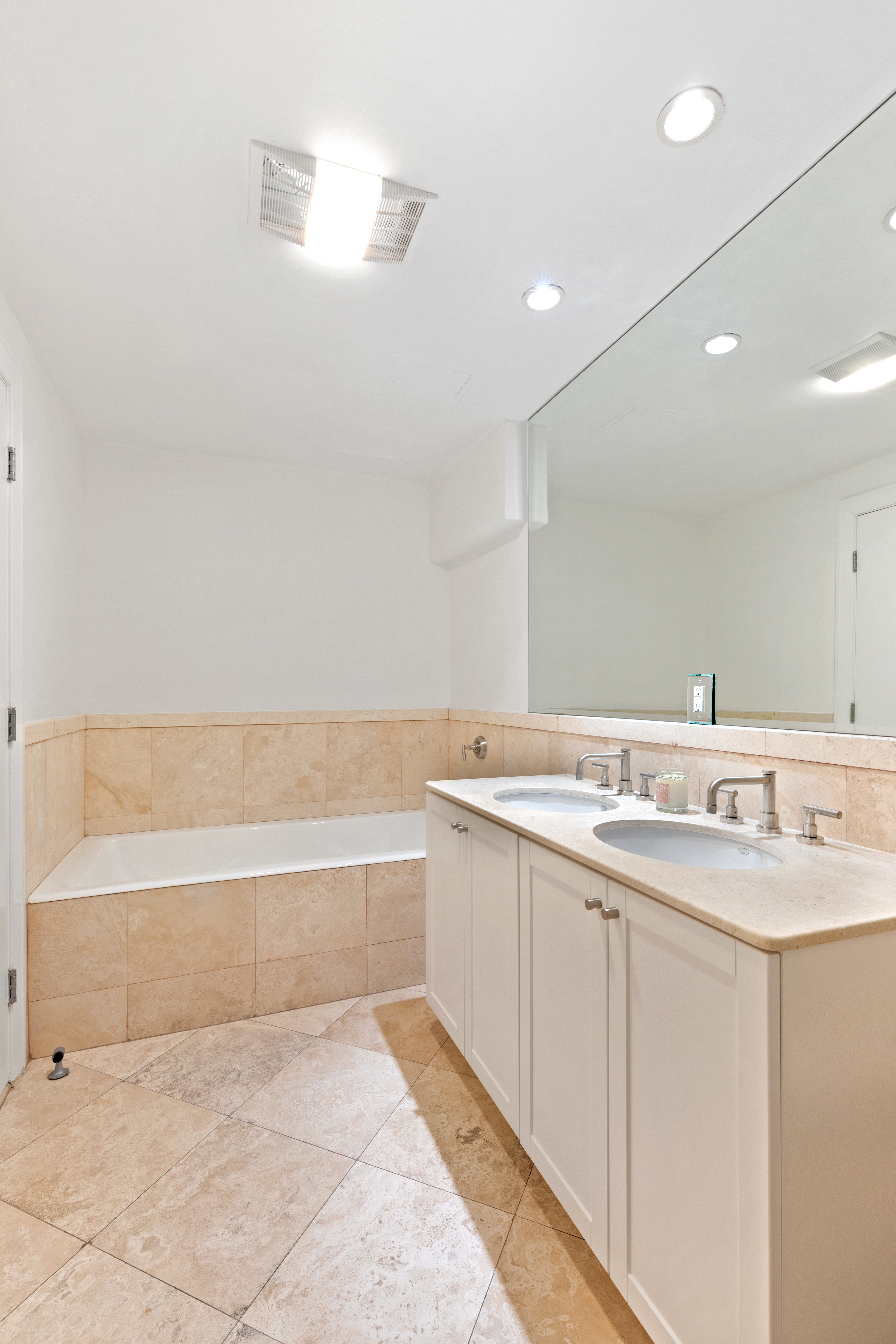 79 Laight Street, Unit 5H Manhattan, NY 10013 - Photo 9 of 13 a bathroom with a tub sink and mirror