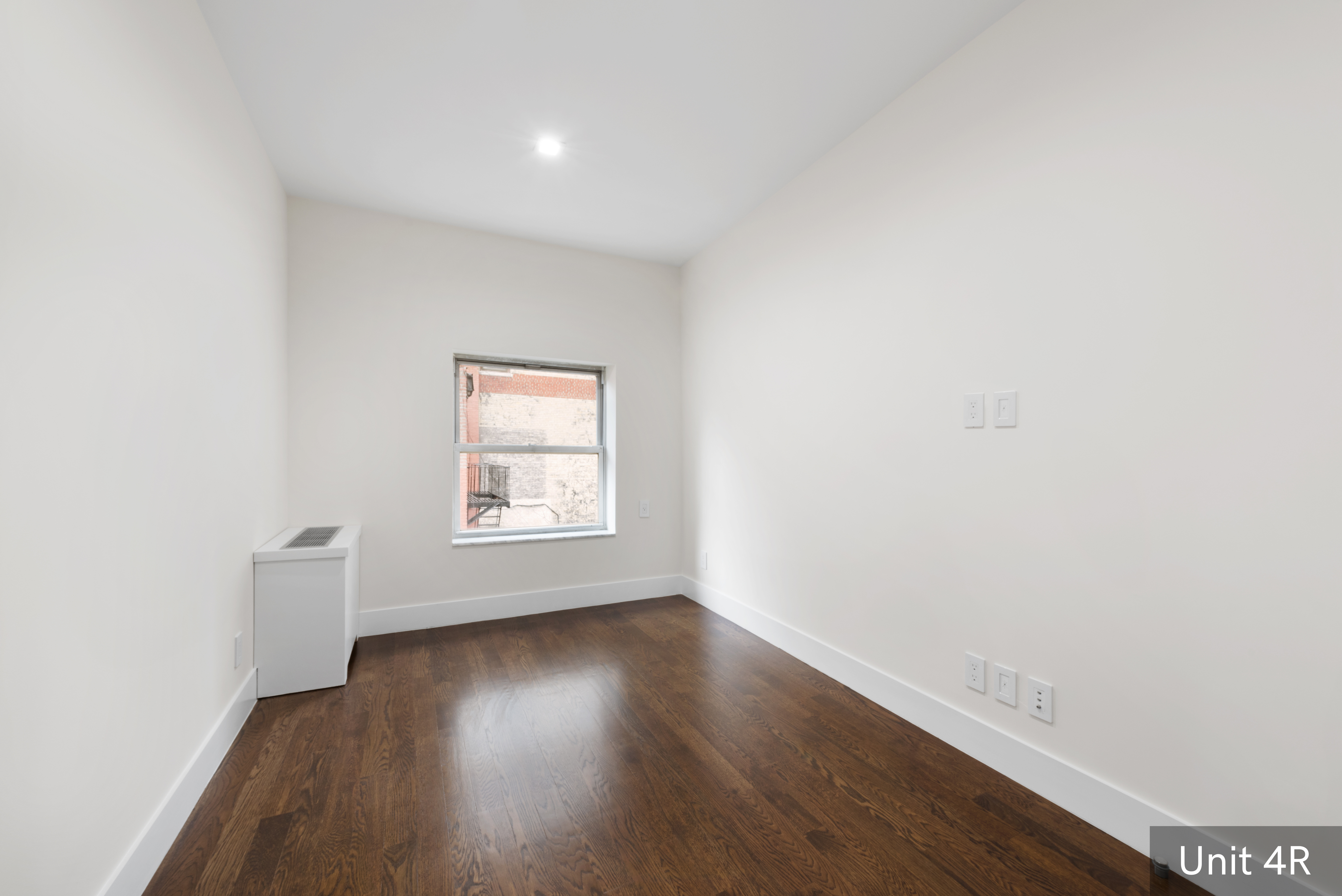 120 East 19th Street Manhattan, NY 10003 - Photo 27 of 33 a view of an empty room with wooden floor and a window