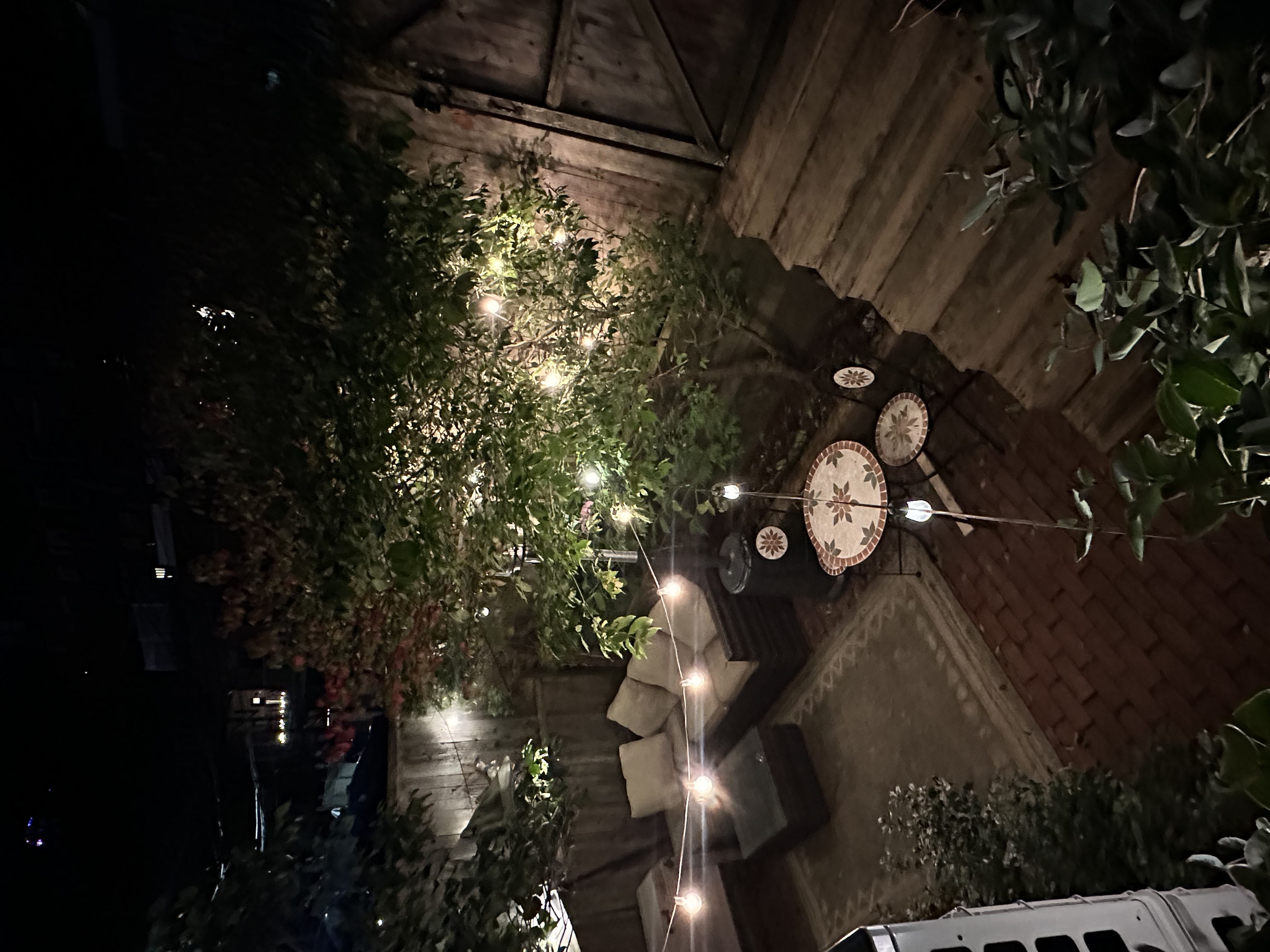 484 Massachusetts Avenue, Unit 1 Boston, MA 02118 - Photo 16 of 20 a backyard of a house with table and chairs with wooden floor