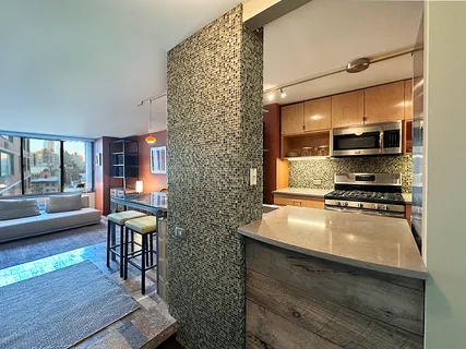 a kitchen with stainless steel appliances a stove a sink and a refrigerator