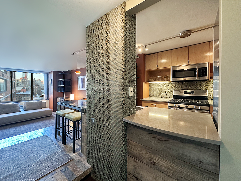 215 West 95th Street, Unit 11A Manhattan, NY 10025 - Photo 5 of 9 a kitchen with stainless steel appliances a stove a sink and a refrigerator