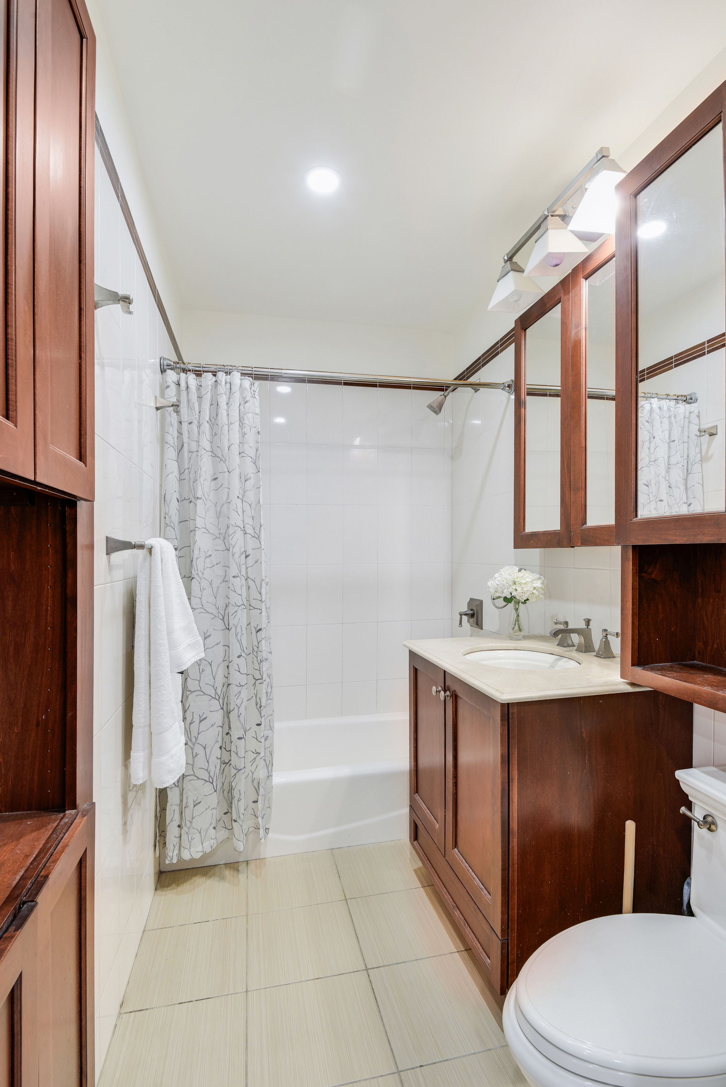 225 West 70th Street, Unit 4B Manhattan, NY 10023 - Photo 7 of 9 a bathroom with a sink a toilet and shower