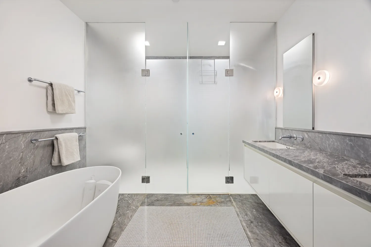a bathroom with a granite countertop sink mirror and bathtub