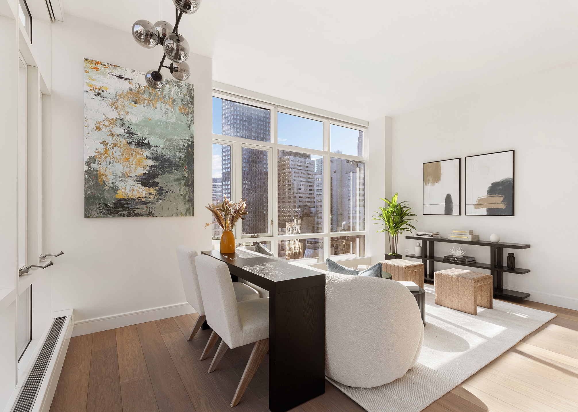 5 Beekman Street, Unit 21B Manhattan, NY 10038 - Photo 5 of 23 a dining room with wooden floor and a chandelier