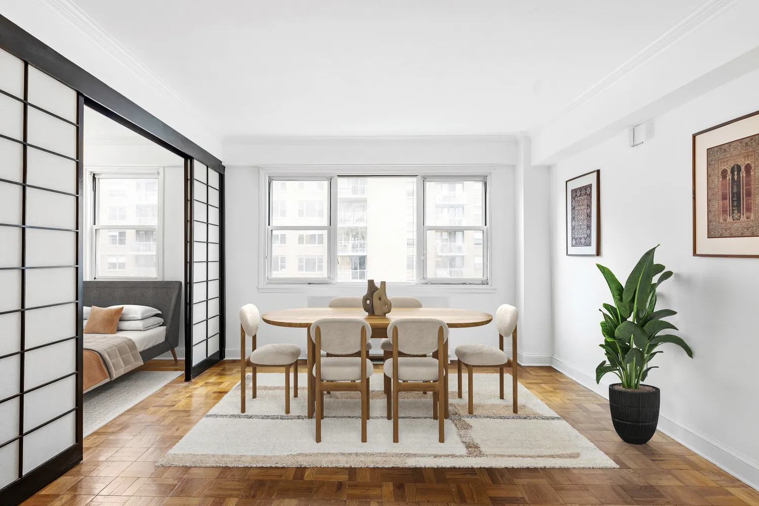 a dining room with wooden floor and large windows