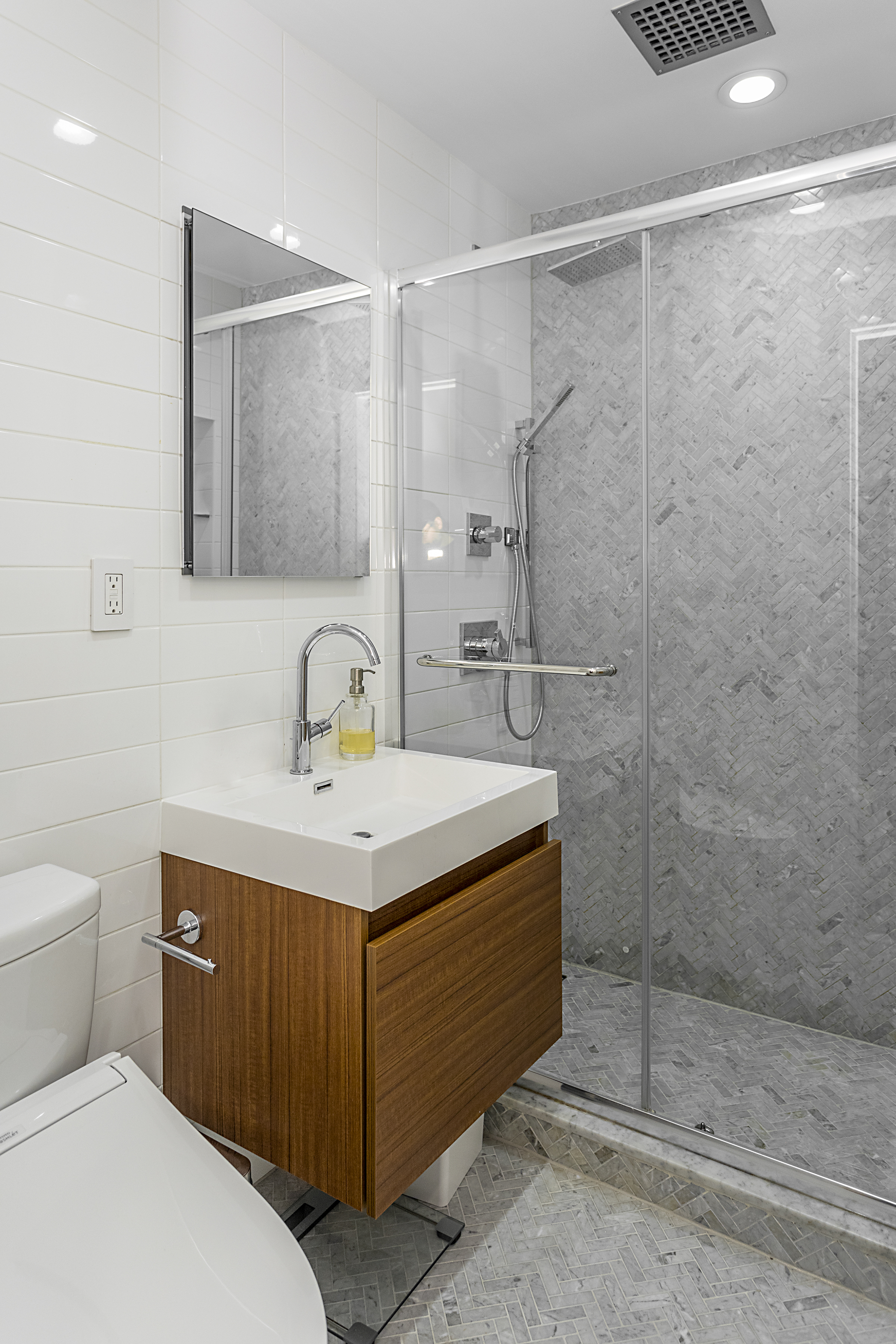 250 West 15th Street, Unit 3C Manhattan, NY 10011 - Photo 7 of 9 a bathroom with a sink a toilet and shower