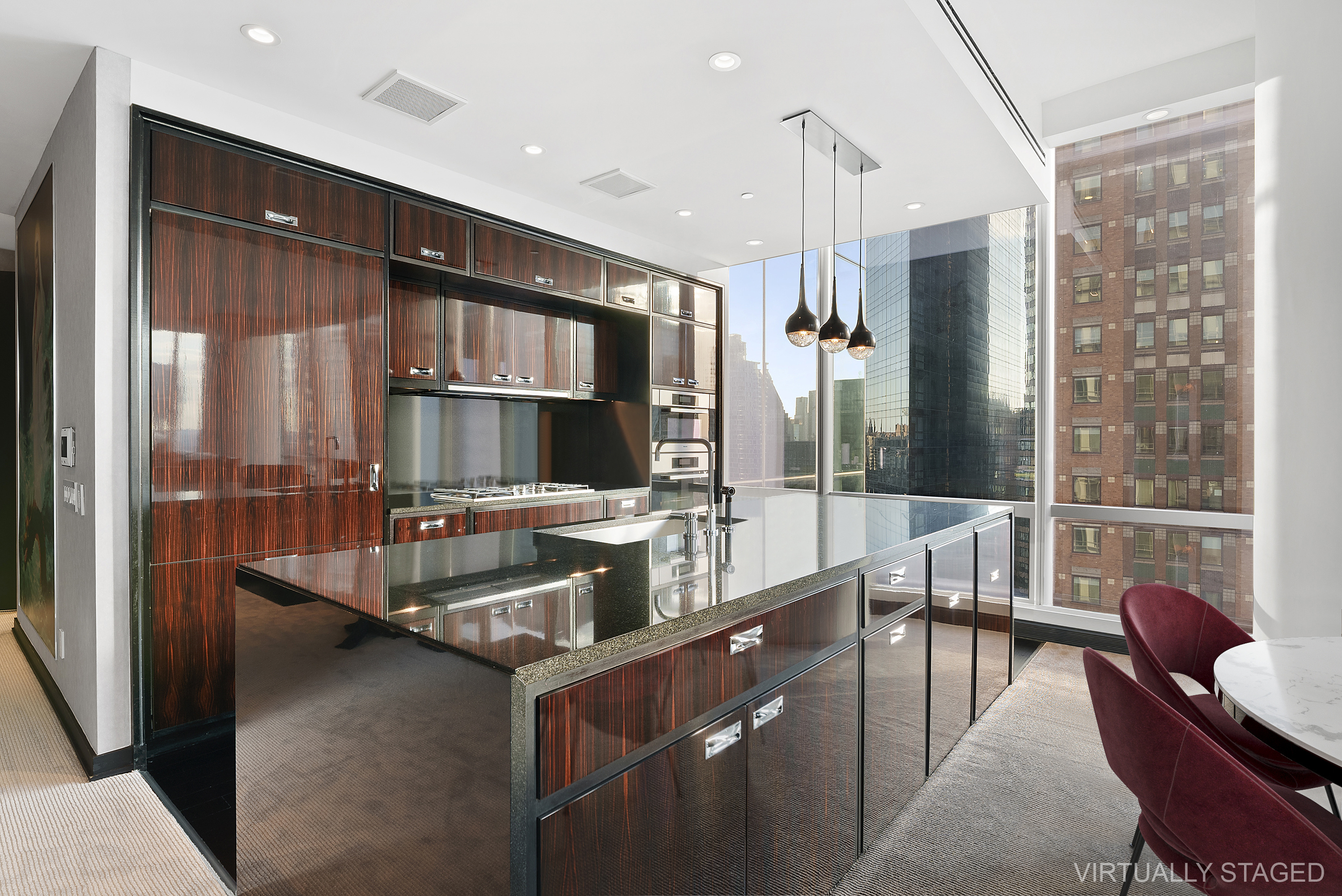 157 West 57th Street, Unit 49B Manhattan, NY 10019 - Photo 3 of 9 a kitchen with stainless steel appliances granite countertop a sink and a refrigerator