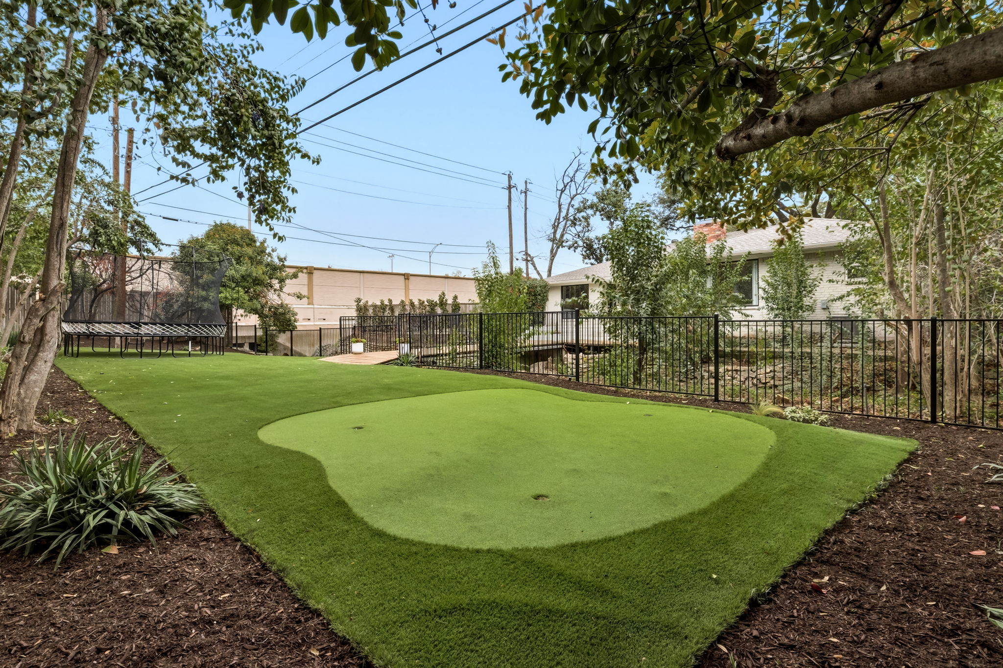 5765 Stonegate Road Dallas, TX 75209 - Photo 37 of 37 a view of a swimming pool with a garden