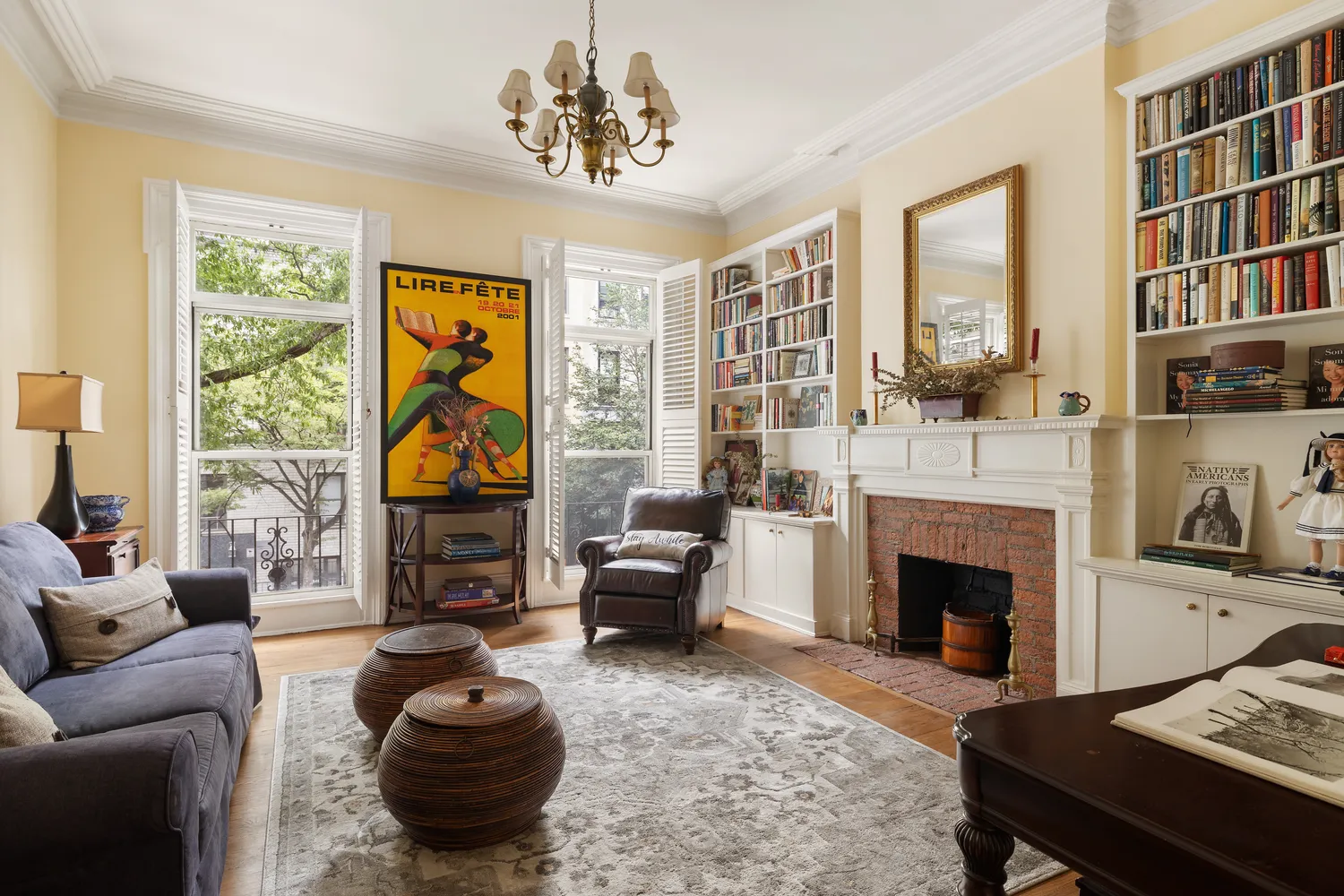 a living room with furniture a fireplace and a large window