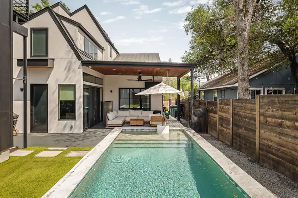 a view of a house with sitting area and a swimming pool