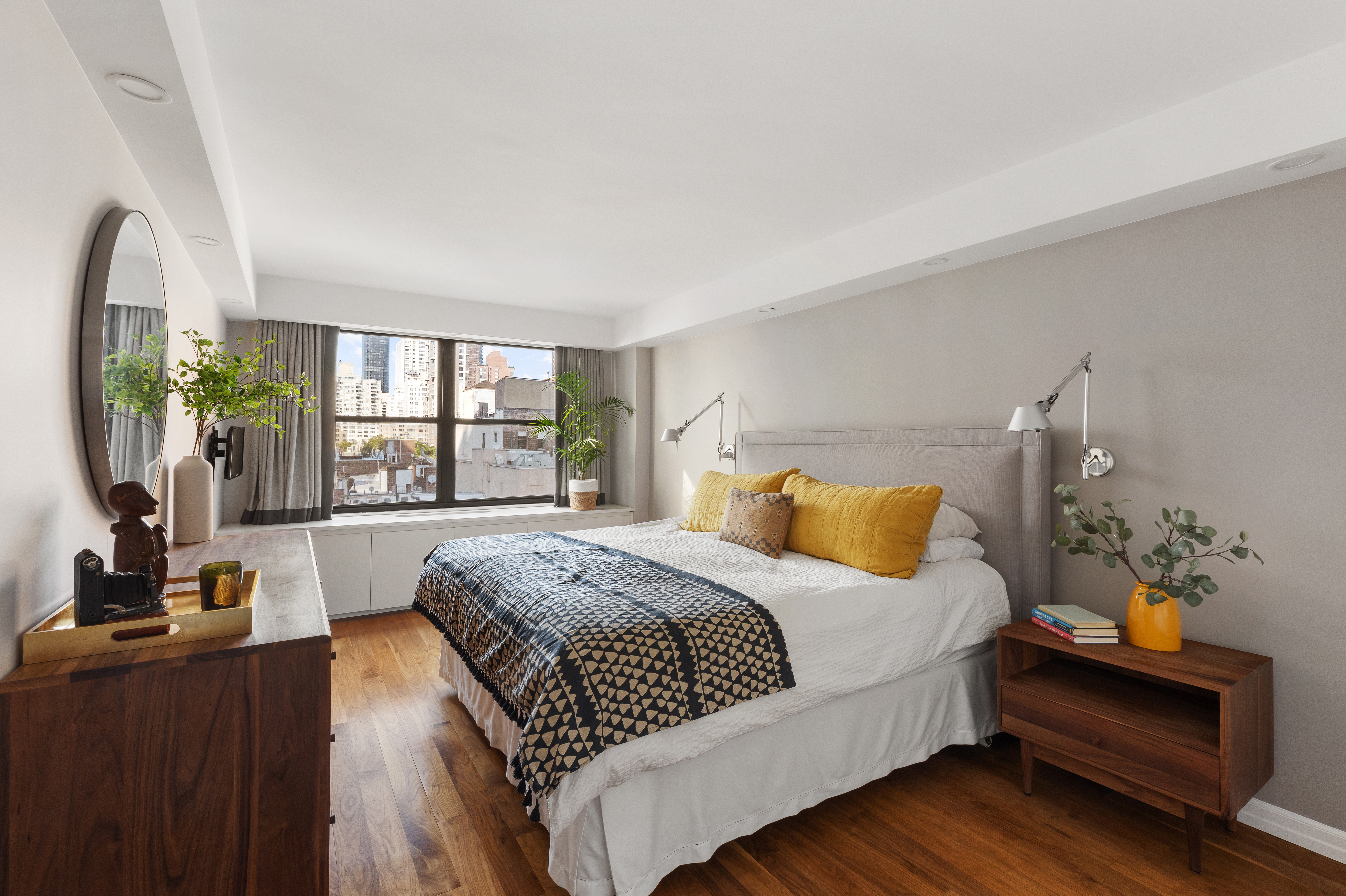 225 East 57th Street, Unit 9M Manhattan, NY 10022 - Photo 6 of 10 a bedroom with a balcony a bed and a couch
