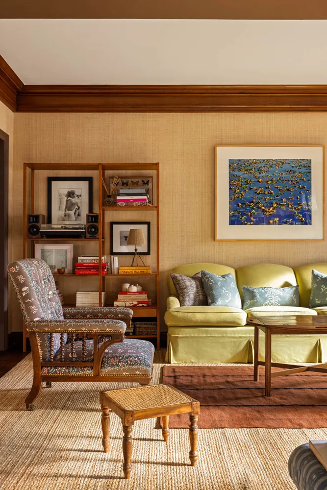 a living room with furniture and painting on the wall