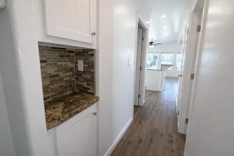 a view of hallway with wooden floor