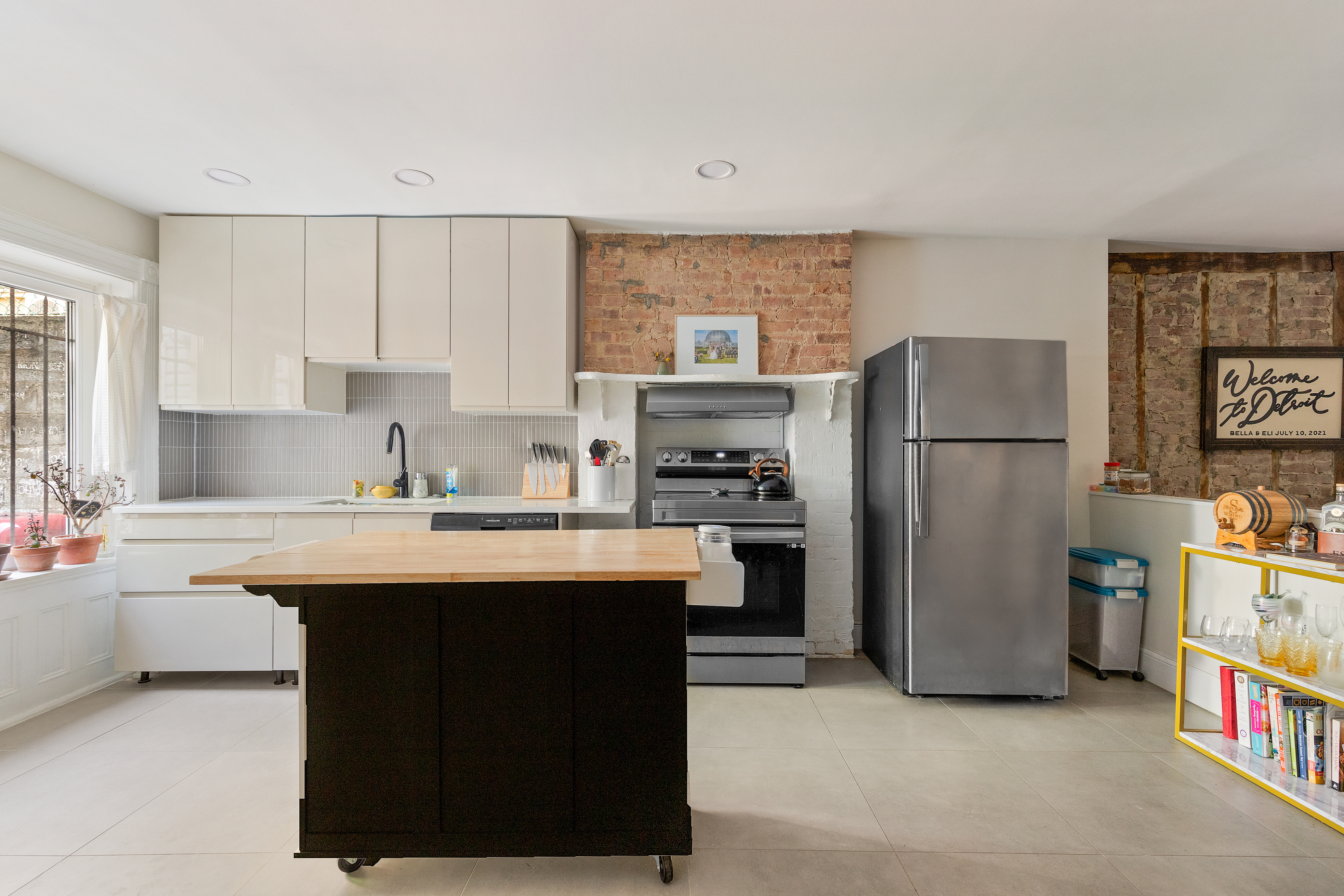 285 Weirfield Street Brooklyn, NY 11221 - Photo 3 of 16 a kitchen with refrigerator a sink and a stove