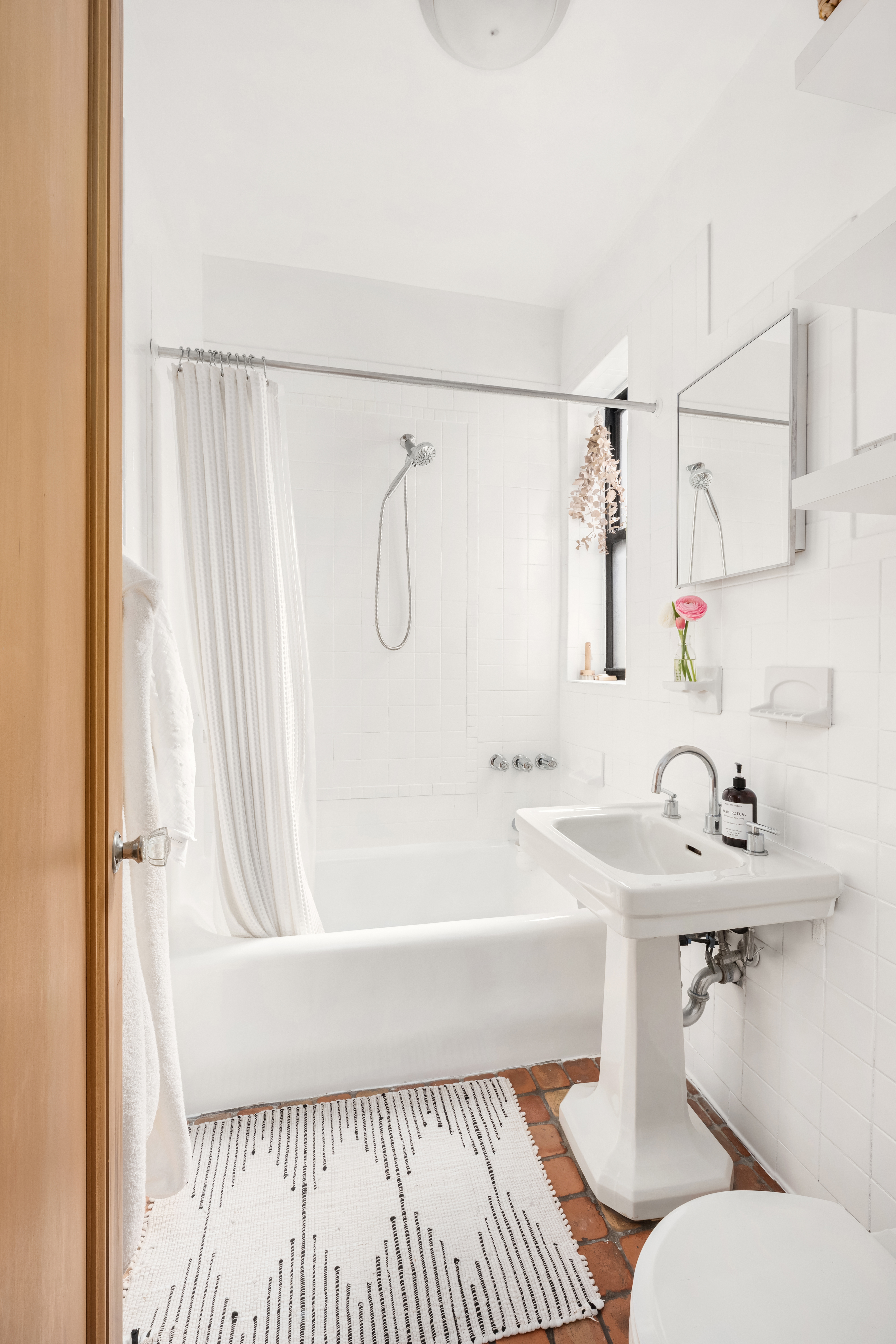 205 East 10th Street, Unit 3A Manhattan, NY 10003 - Photo 7 of 13 a bathroom with a sink toilet and shower