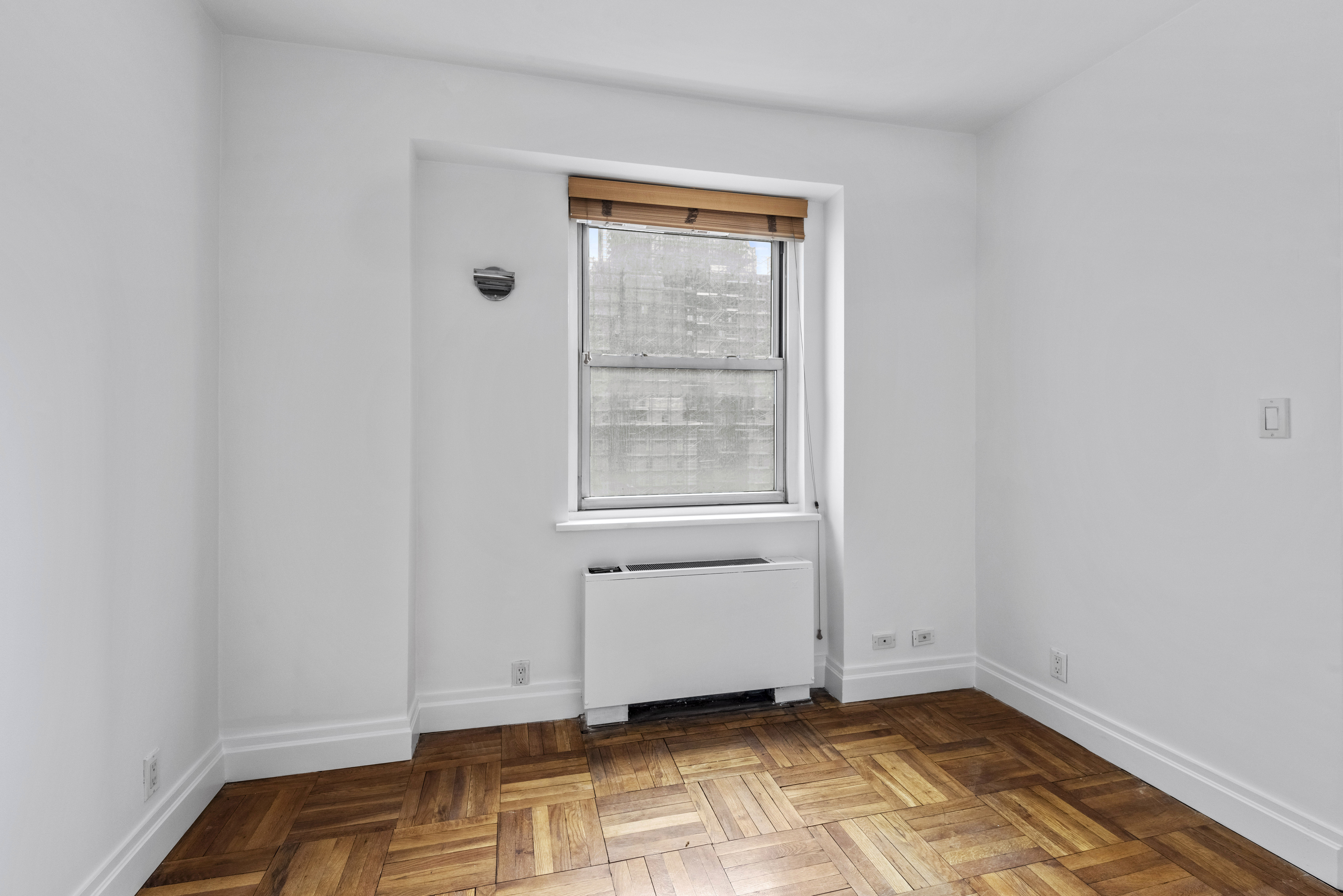 175 East 62nd Street, Unit 12A Manhattan, NY 10065 - Photo 23 of 24 a view of an empty room with a window