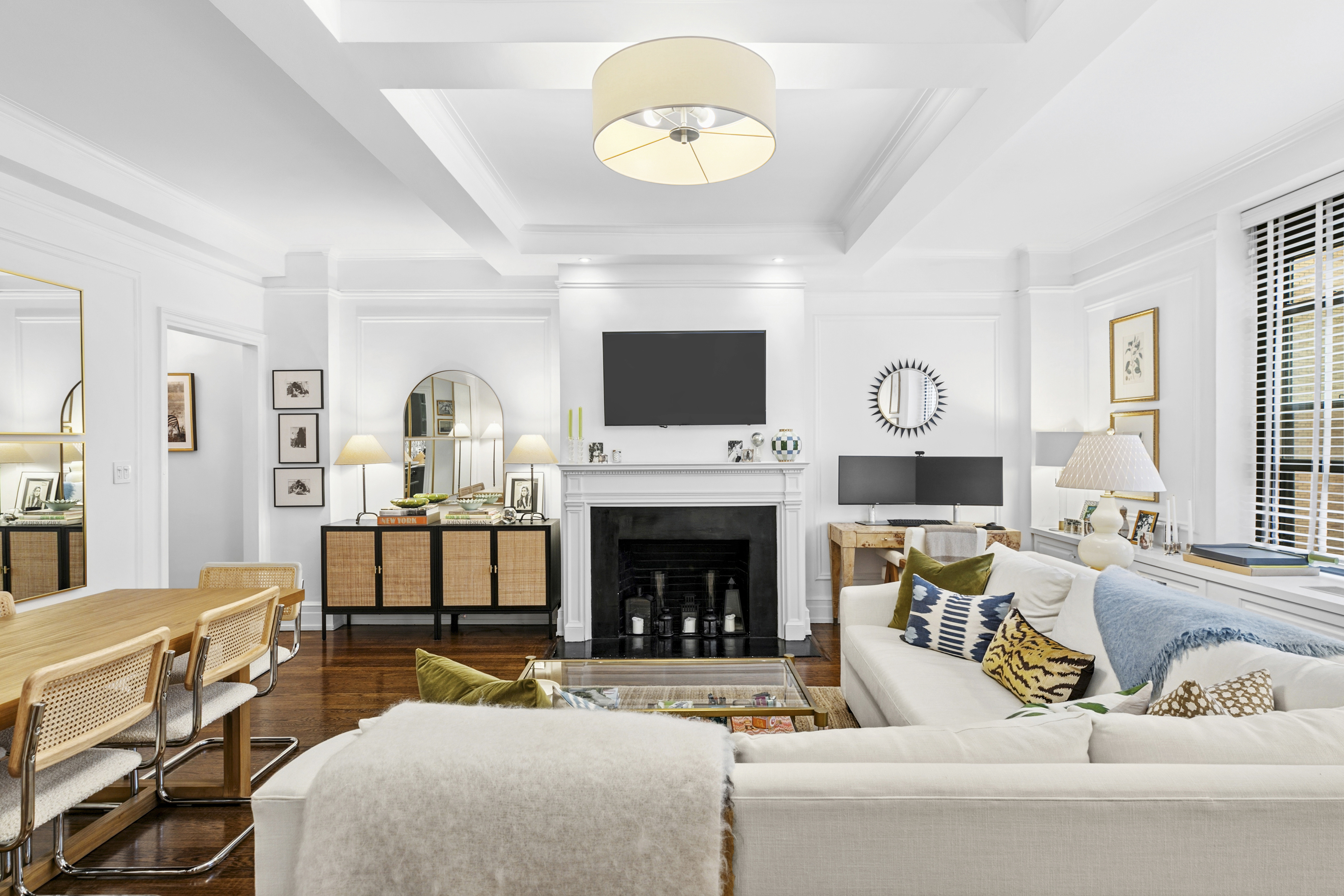 175 East 79th Street, Unit 3D Manhattan, NY 10075 - Photo 1 of 8 a living room with furniture a fireplace and a flat screen tv