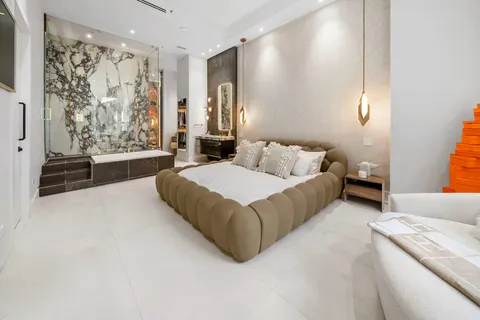 a bedroom with a bed and a couch