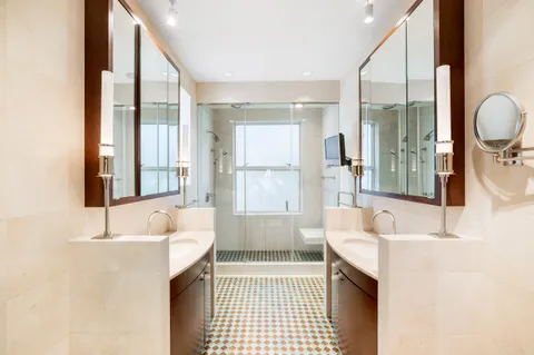 a bathroom with a tub sink and mirror