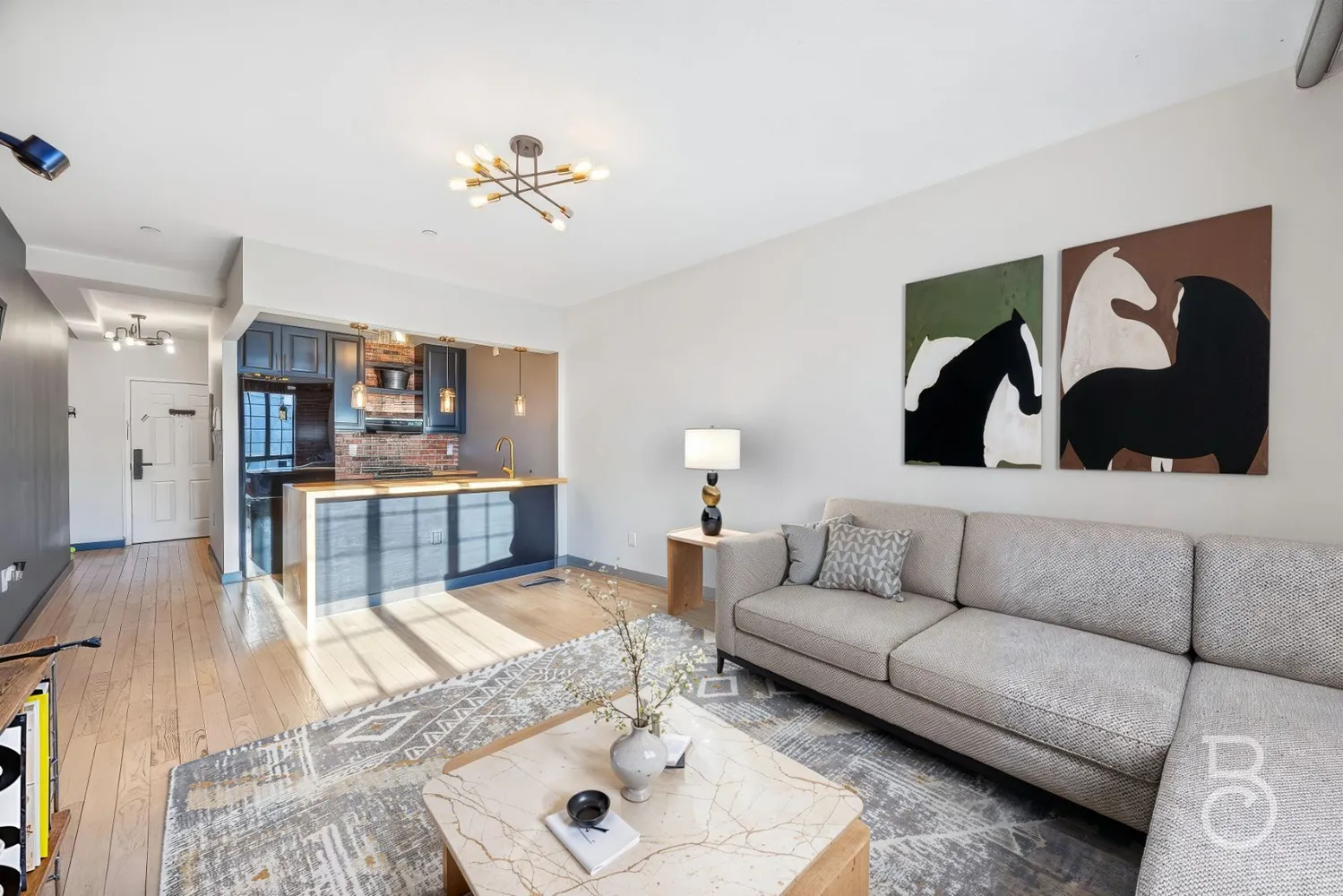 a living room with furniture and a wooden floor