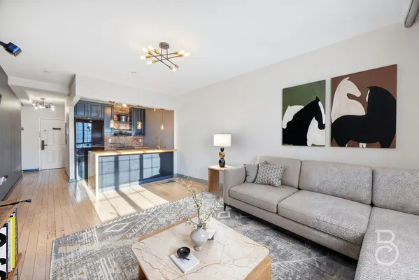 a living room with furniture and a wooden floor