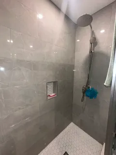 a bedroom with bed and a mirror