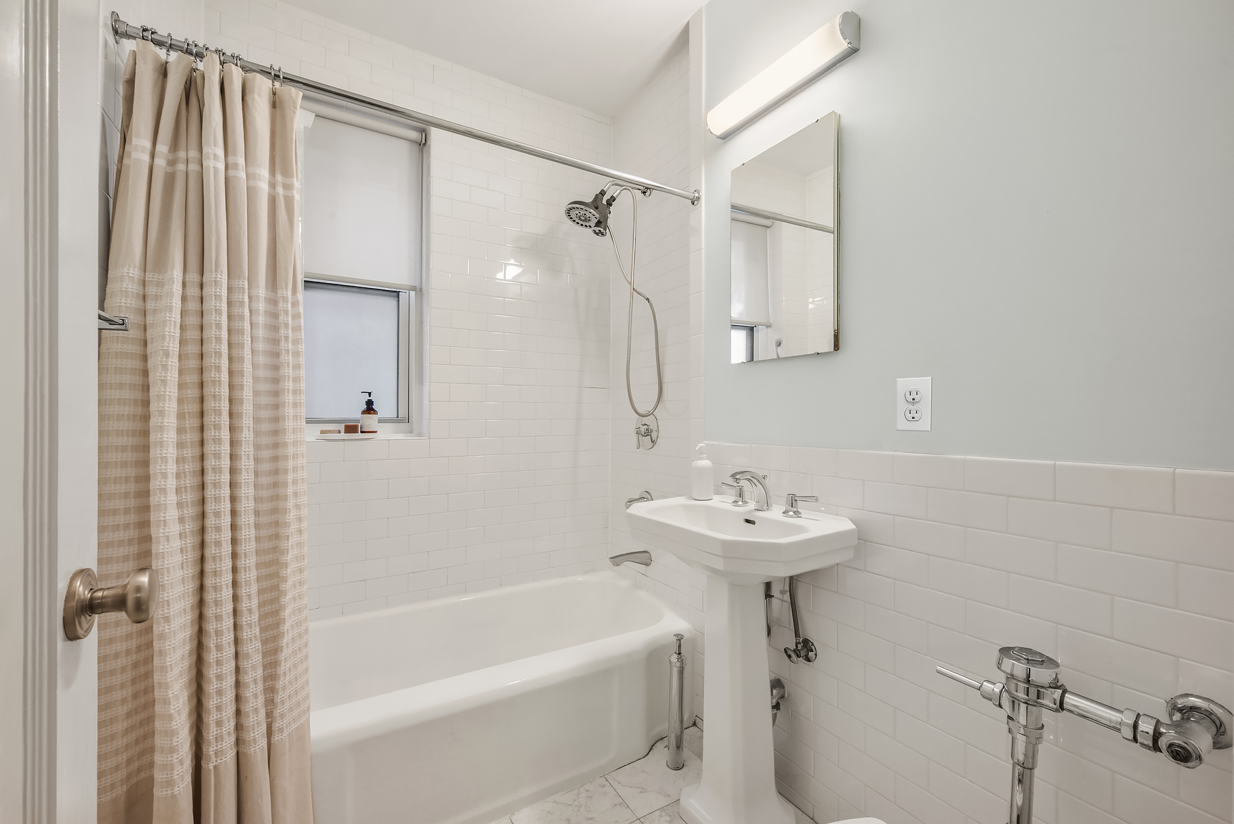 360 Clinton Avenue, Unit 4C Brooklyn, NY 11238 - Photo 8 of 13 a bathroom with a sink a mirror and a bathtub