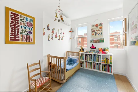 a bedroom with furniture and a book shelf
