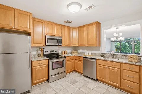 a utility room with cabinets washer and dryer