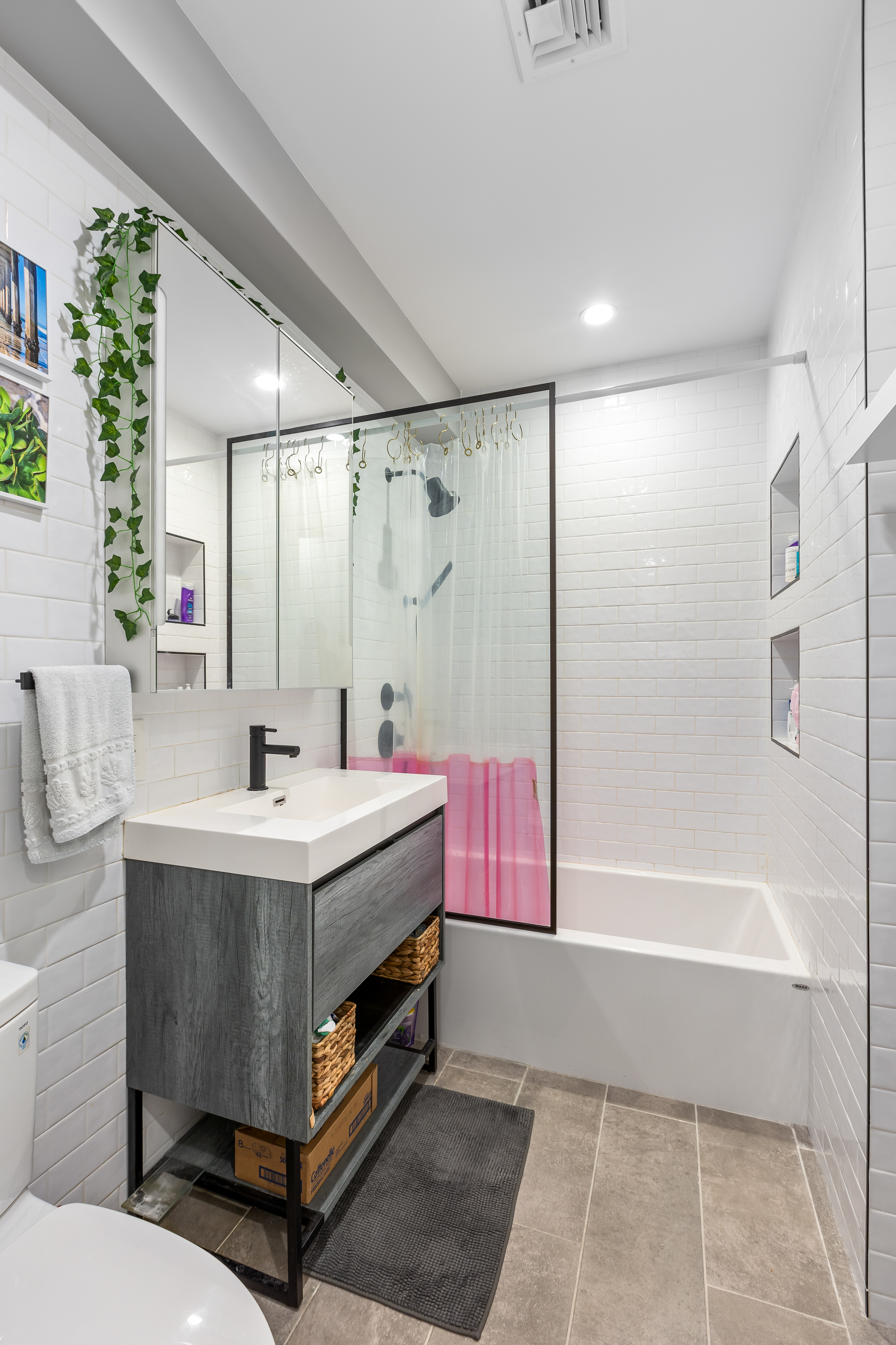 1390 Putnam Avenue, Unit 1F Brooklyn, NY 11221 - Photo 6 of 9 a bathroom with a tub sink and mirror