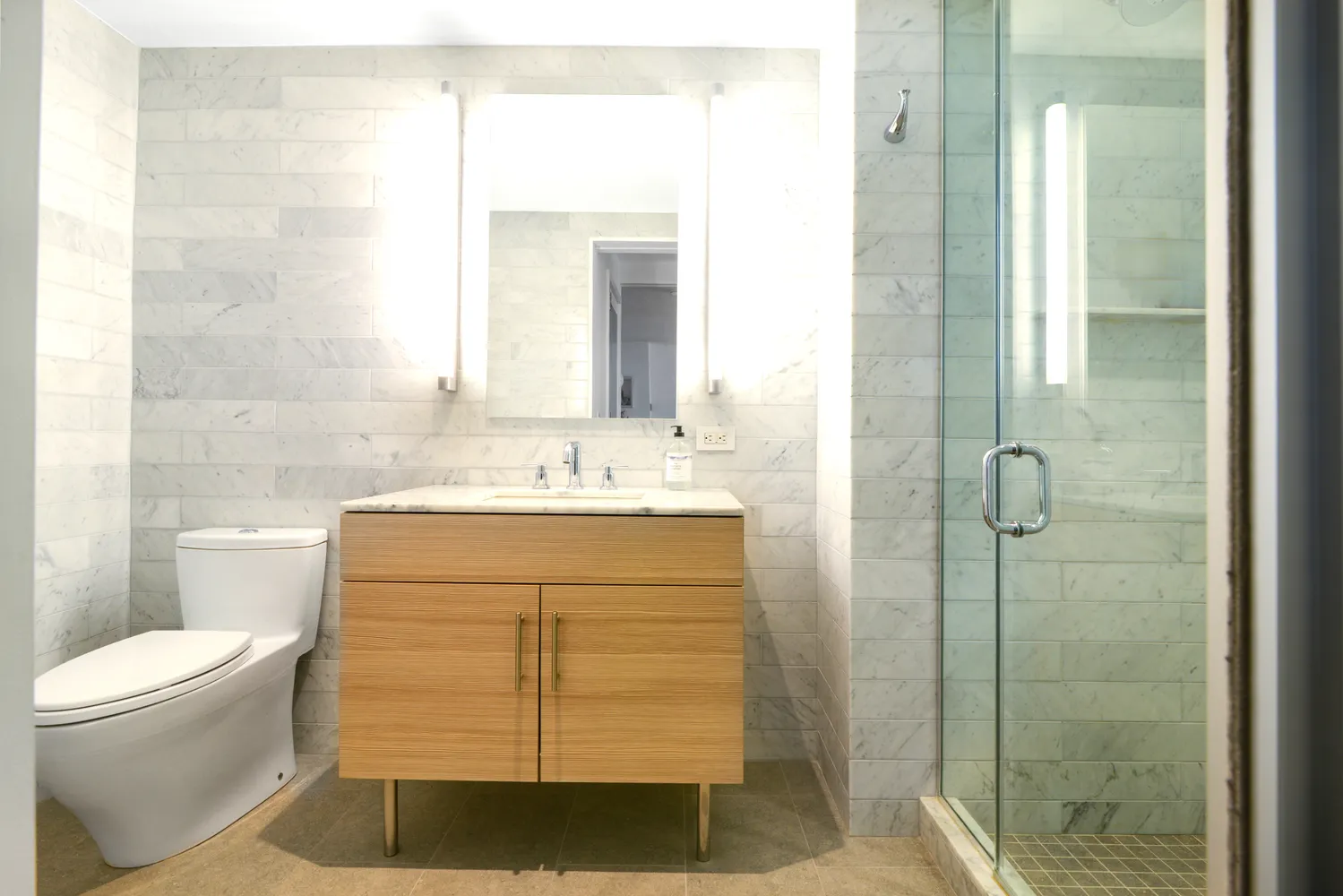 a bathroom with a sink toilet and shower