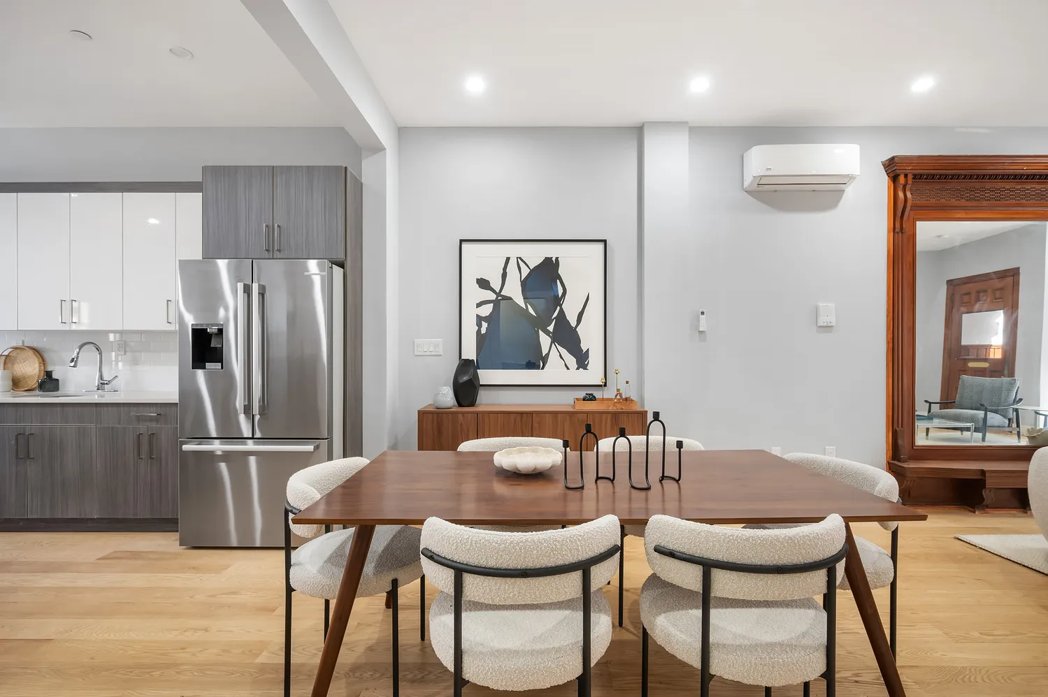 a view of a dining room with furniture and a refrigerator