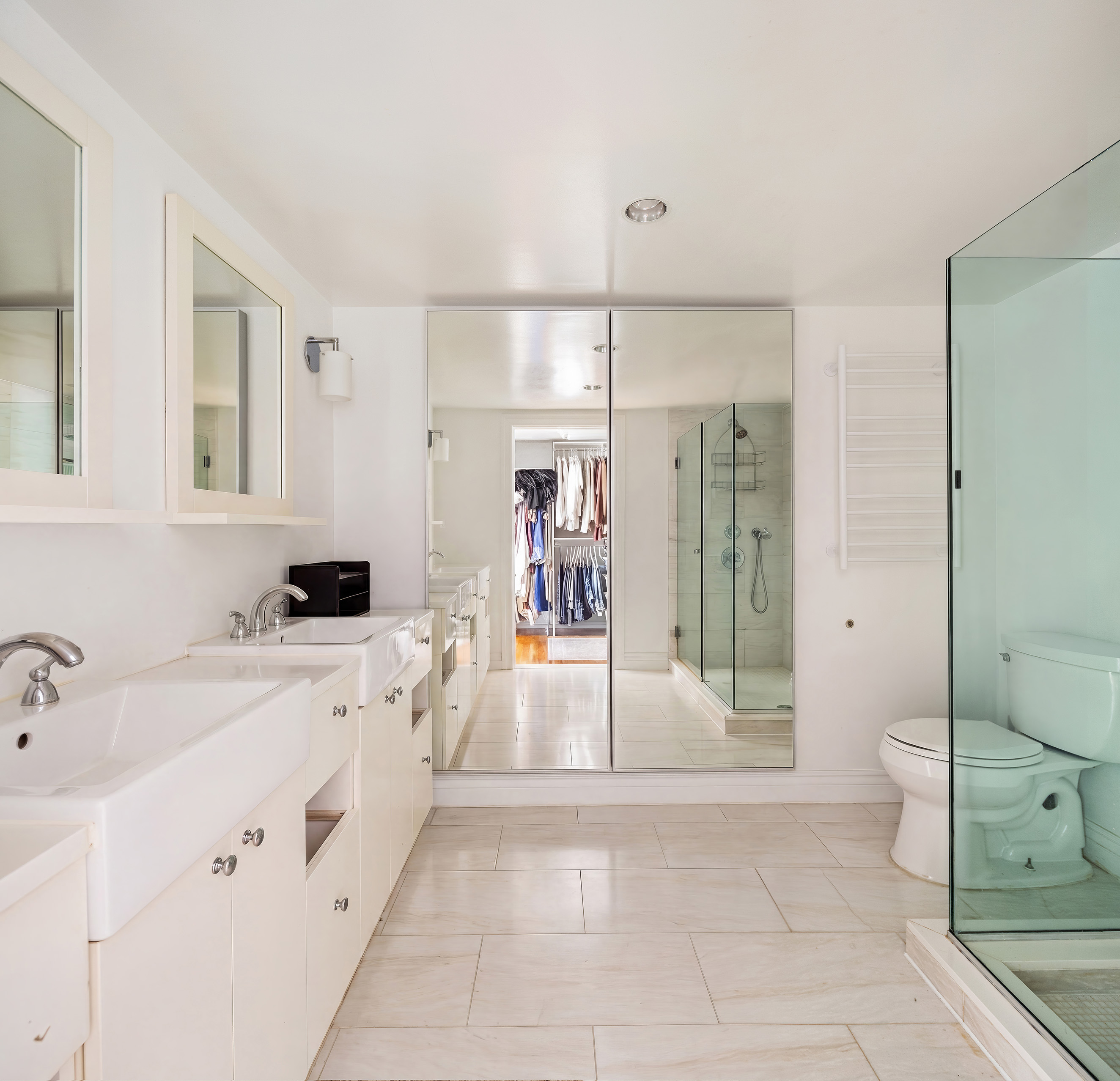341 West 29th Street, Unit 1 Manhattan, NY 10001 - Photo 8 of 11 a large white bathroom with a tub sink mirror and shower