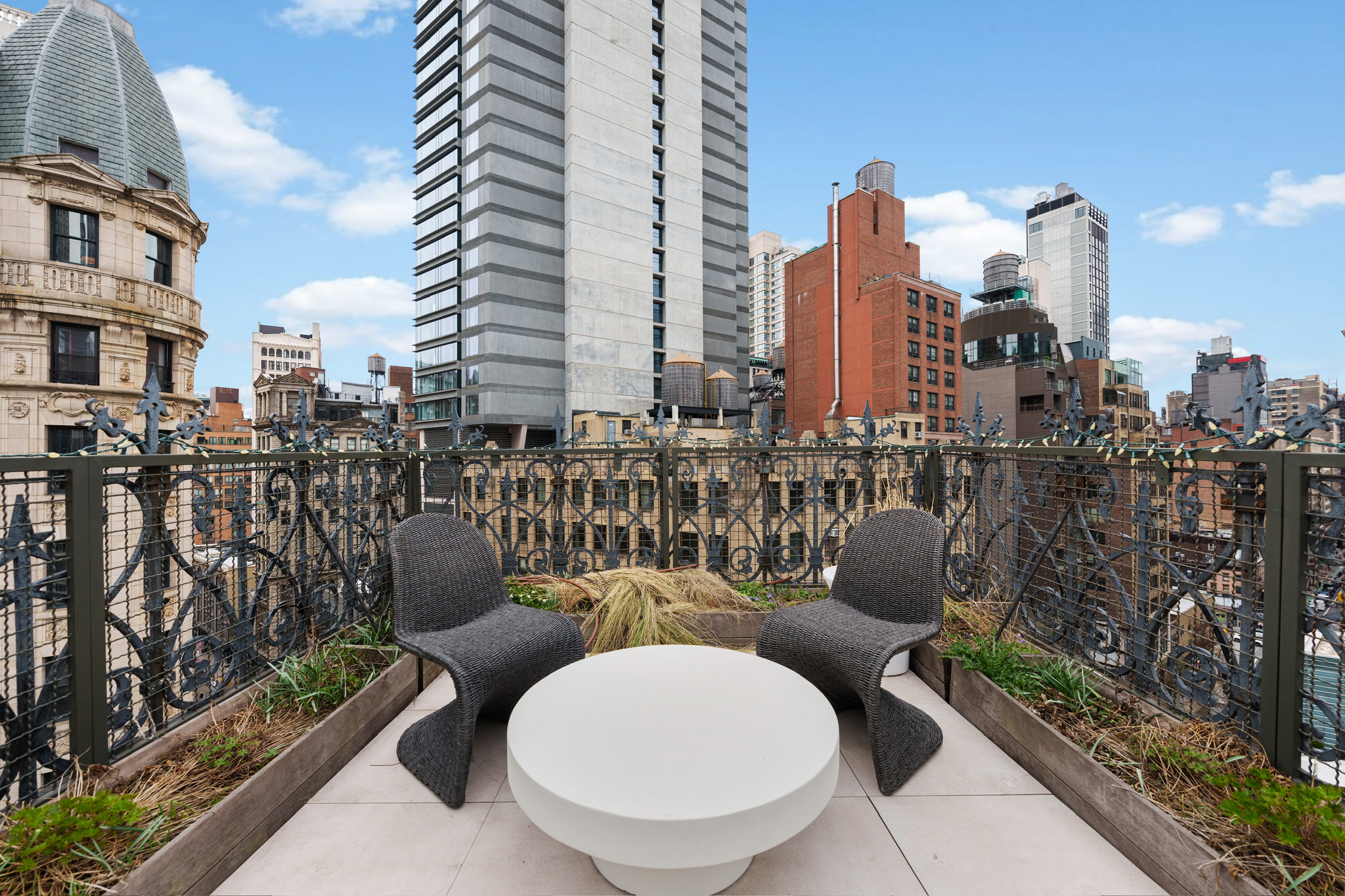 1200 Broadway, Unit PH89 Manhattan, NY 10001 - Photo 35 of 47 a couple of chairs sitting in patio with a barbeque