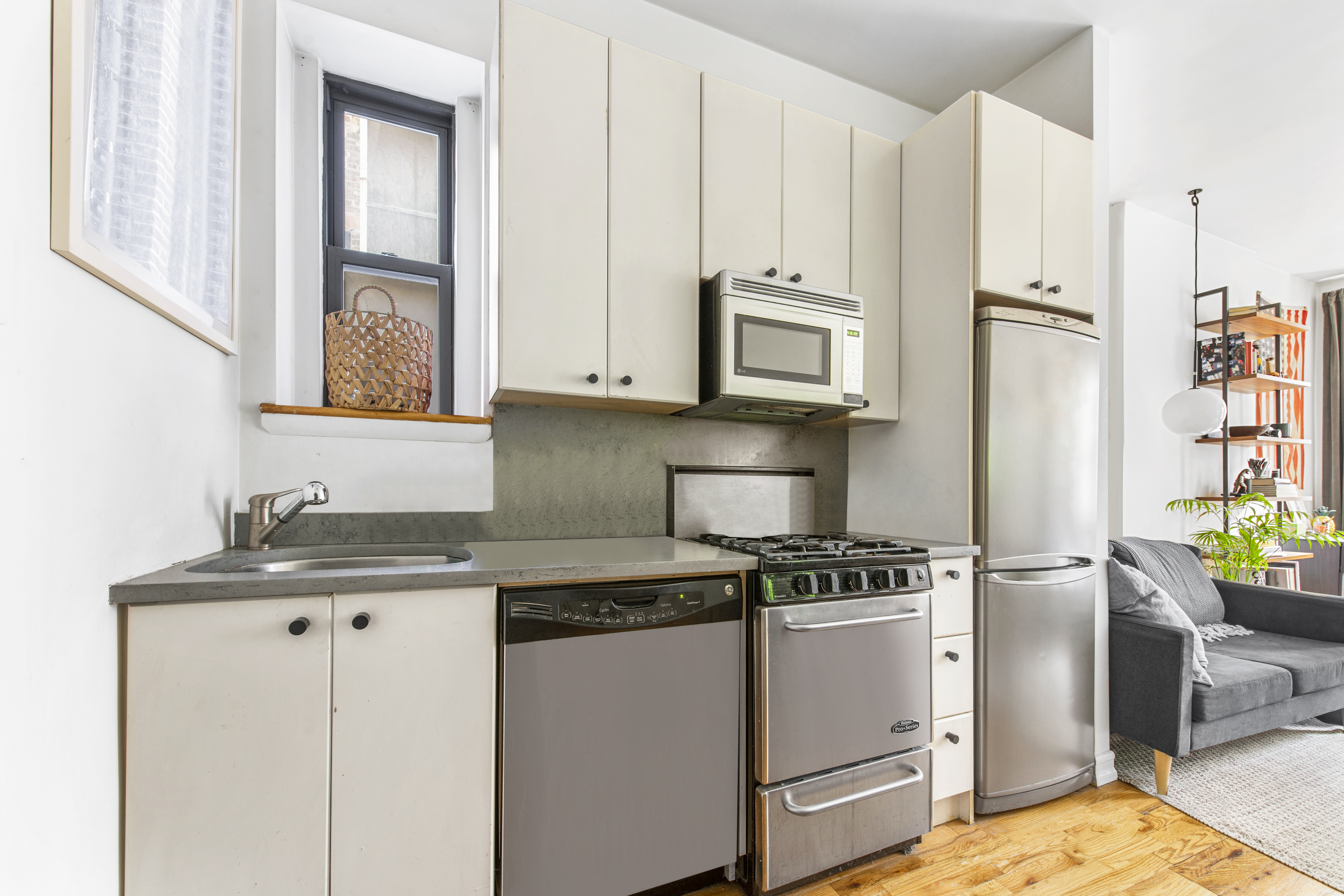 237 East 88th Street, Unit 303 Manhattan, NY 10128 - Photo 3 of 4 a kitchen with appliances cabinets and a counter top space