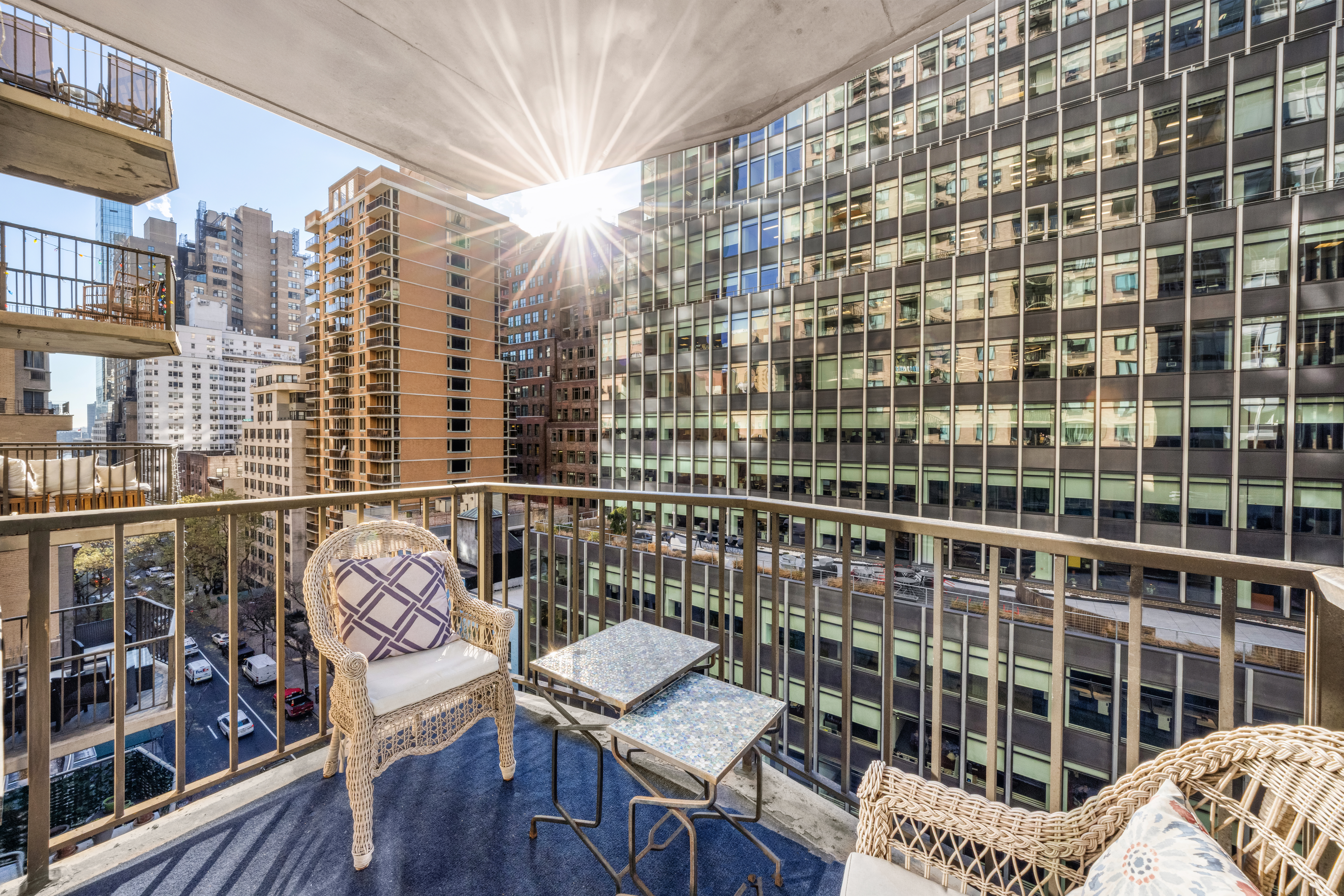 E 47th St, Unit 10H Manhattan, NY 10017 - Photo 5 of 10 a view of balcony with a couch and wooden floor
