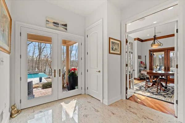 a spacious bathroom with a granite countertop tub a sink and a large window