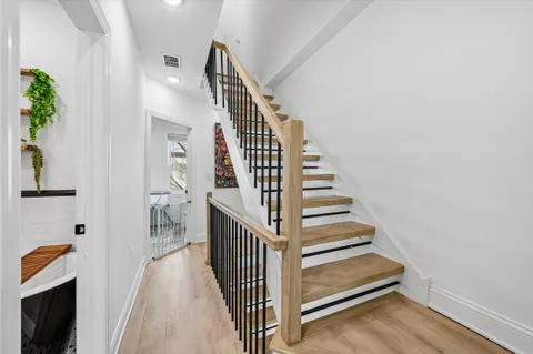 a view of entryway and hall with wooden floor