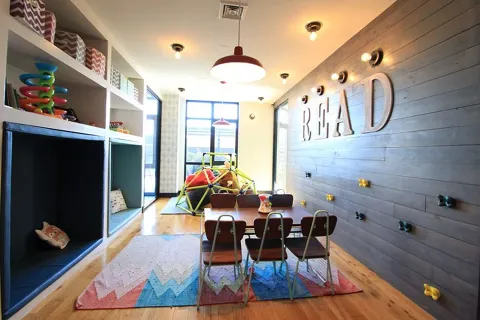 a view of a dining room with furniture and a chandelier