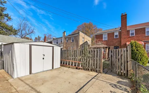 a view of a house with a wooden fence